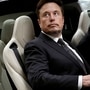  Tesla Chief Executive Officer Elon Musk gets in a Tesla car as he leaves a hotel in Beijing. Recently he shared a video of him exercising in the middle of a meeting (REUTERS)